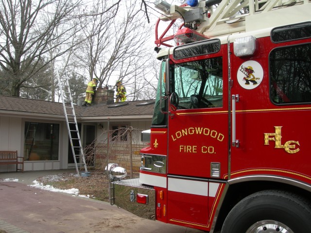 Firefighters working to extinguish a chimney fire.